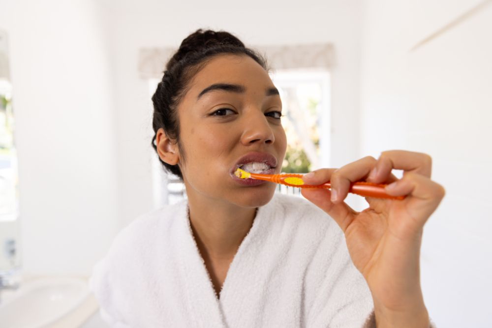 black woman brushing dental crown