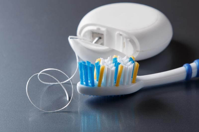 A toothbrush and dental floss on a table