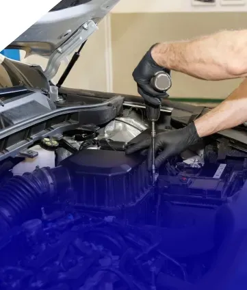 Technician performing repairs on engine under car hood | Eurocharged