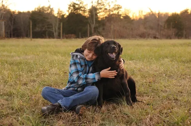 Kid with His Black Dog — Winston-Salem, NC — A Dog's Purpose