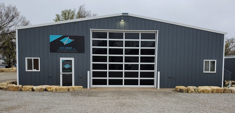 A large gray building with a large garage door