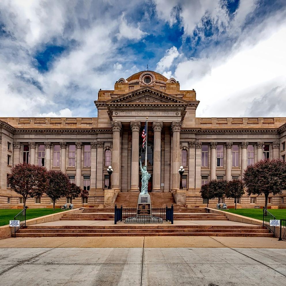 A large building with a statue of liberty in front of it