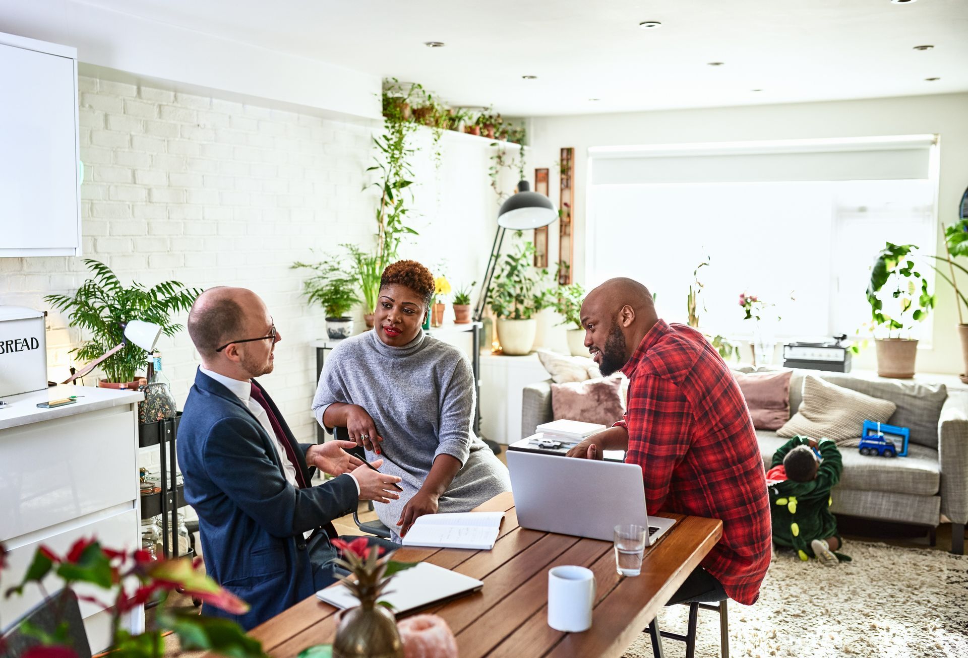 A Man is Talking to a Woman and a Man while Sitting at a Table With a Laptop — Rogers, MN — Supplement Negotiators LLC