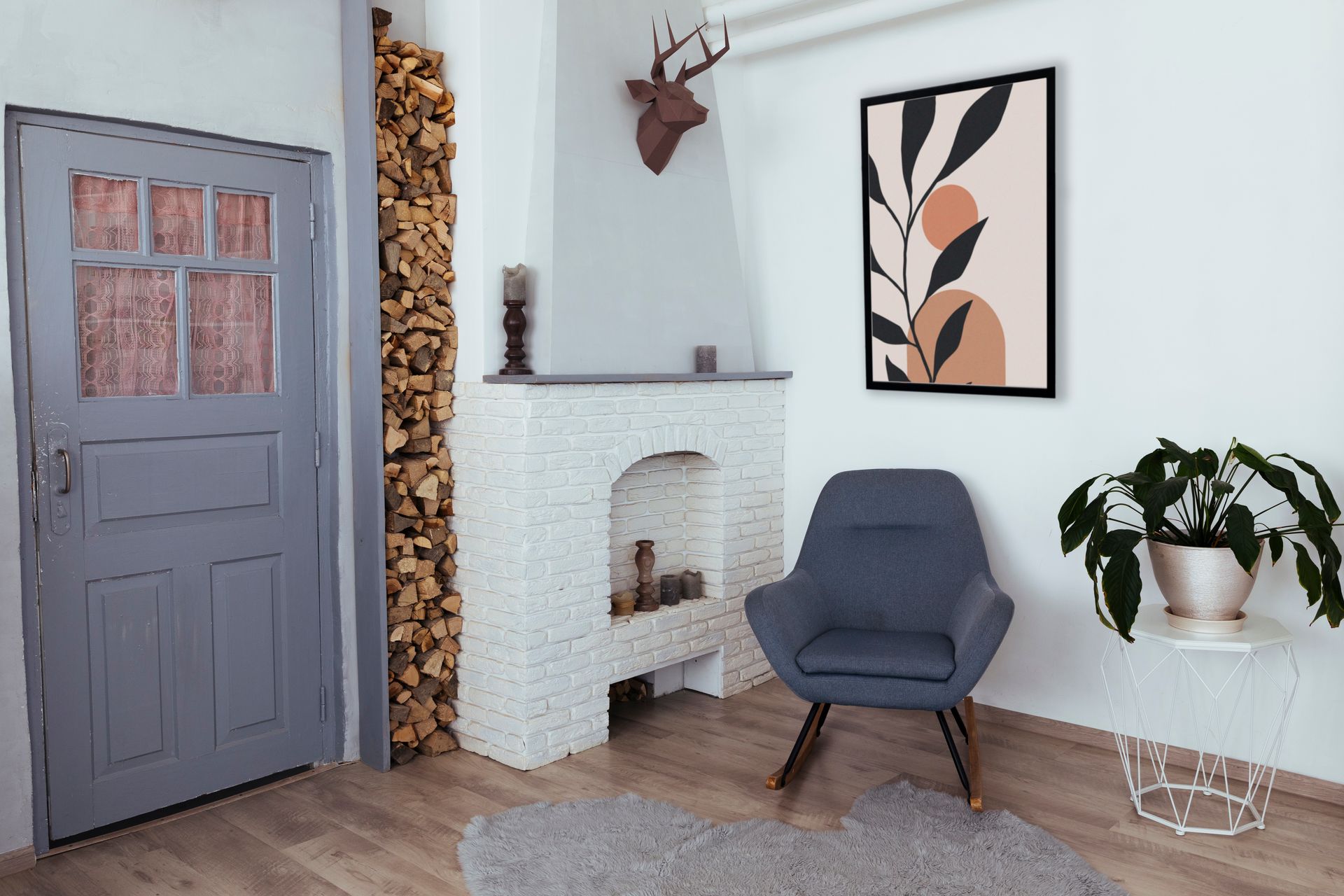 A cozy living room with a fireplace, art, and a chair. Gray door and wooden floor.