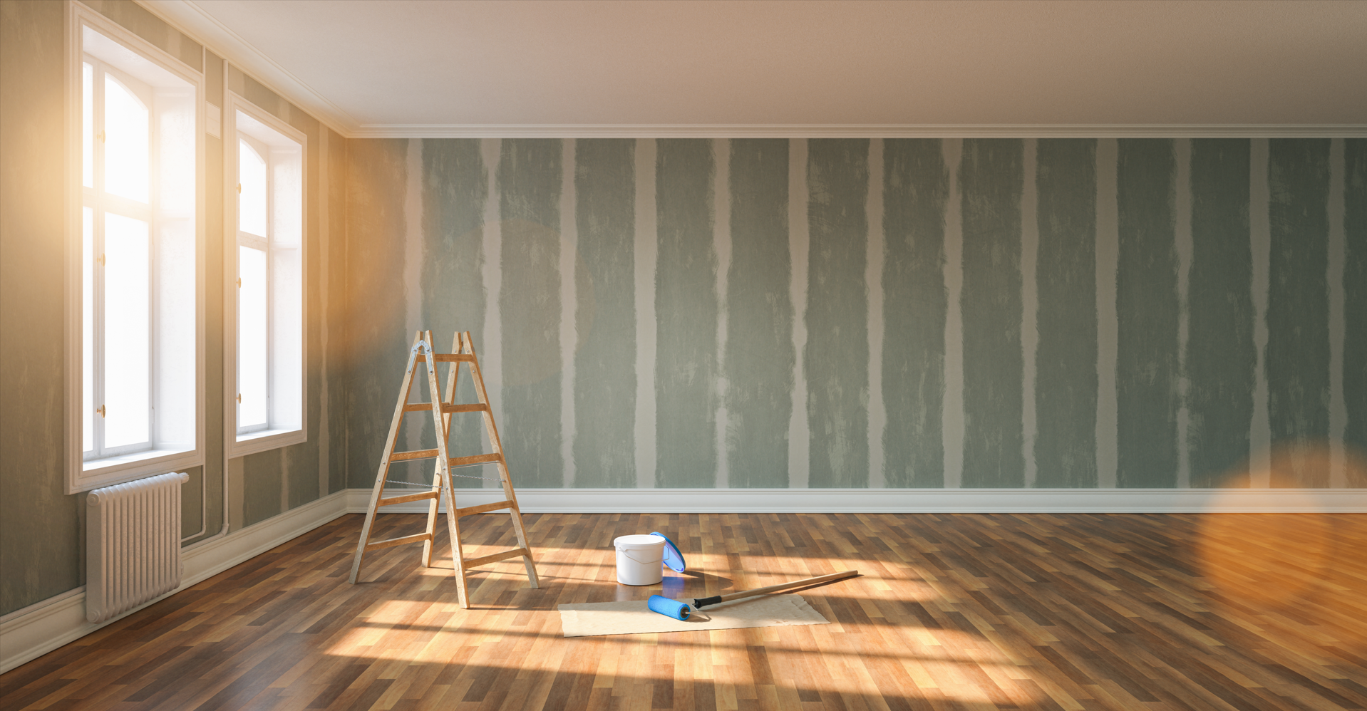 An empty room with a wooden floor and a ladder.