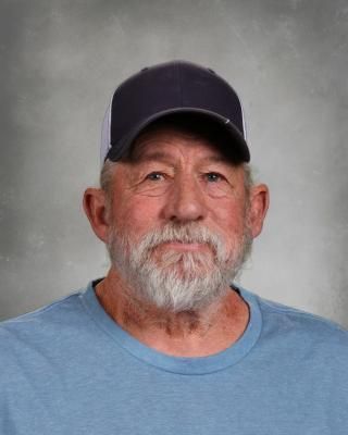 A man with a beard wearing a hat and glasses.