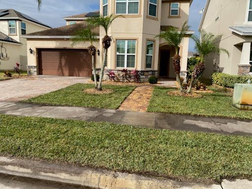A large house with a lush green lawn in front of it.