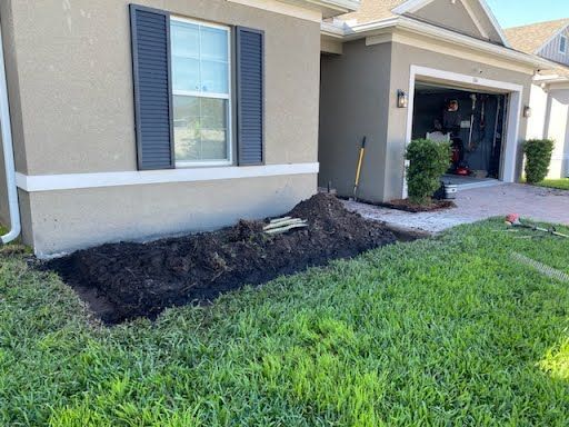A pile of dirt is sitting in front of a house.