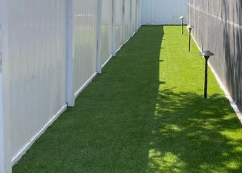 A brick walkway leading to the front door of a house.