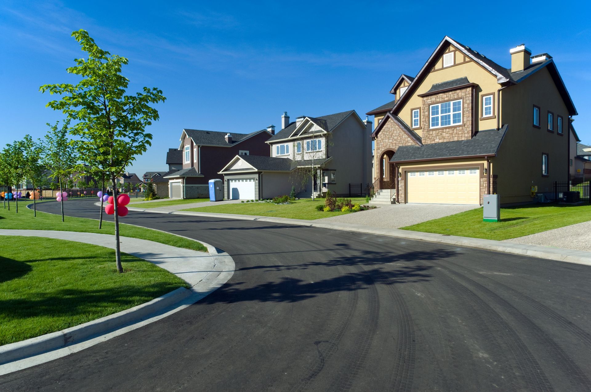 A row of houses in a residential neighborhood on a sunny day
