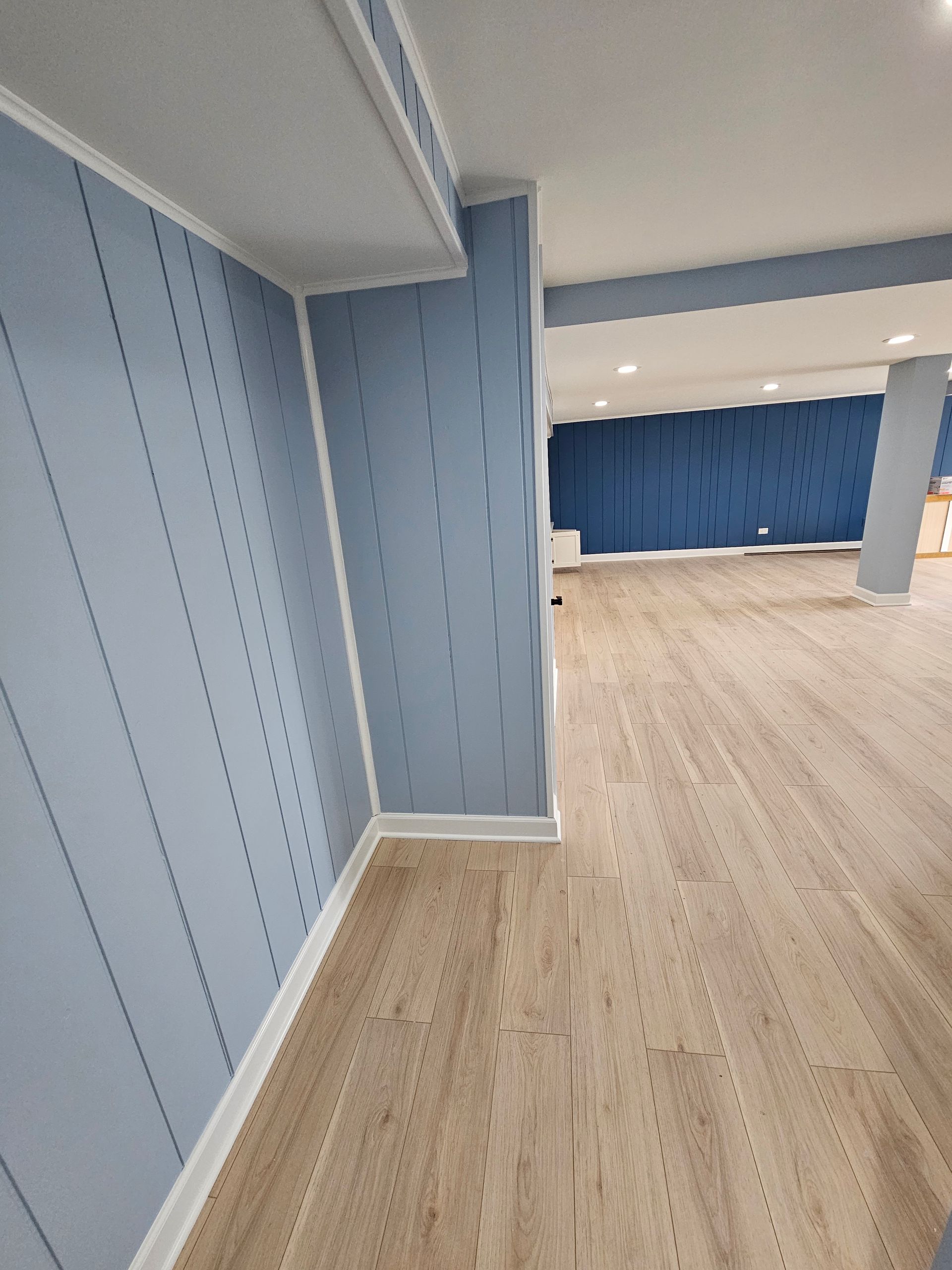 A room with blue walls and wooden floors.