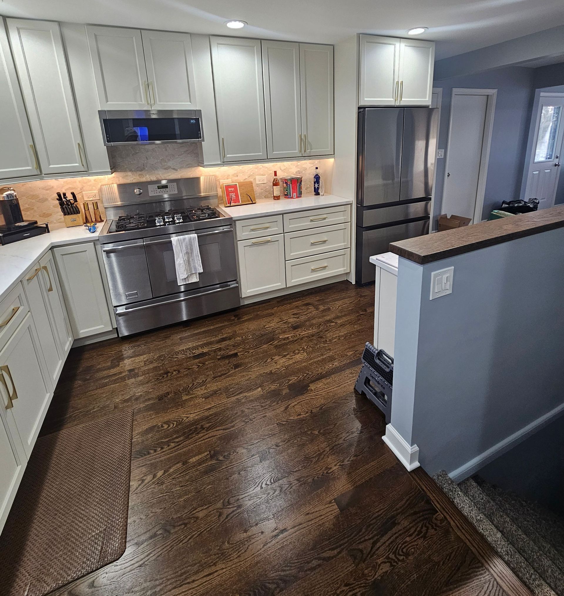 A kitchen with stainless steel appliances and white cabinets