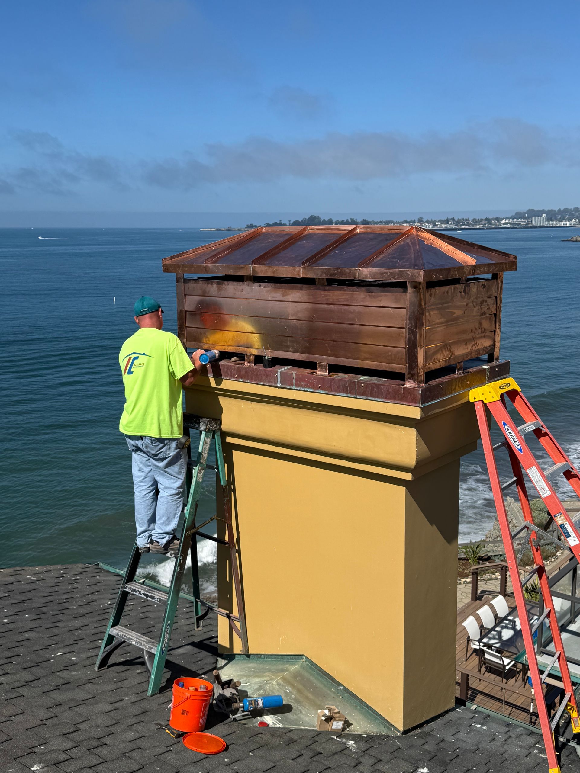 White ceiling-mounted bathroom exhaust fan with square, slatted vent design.