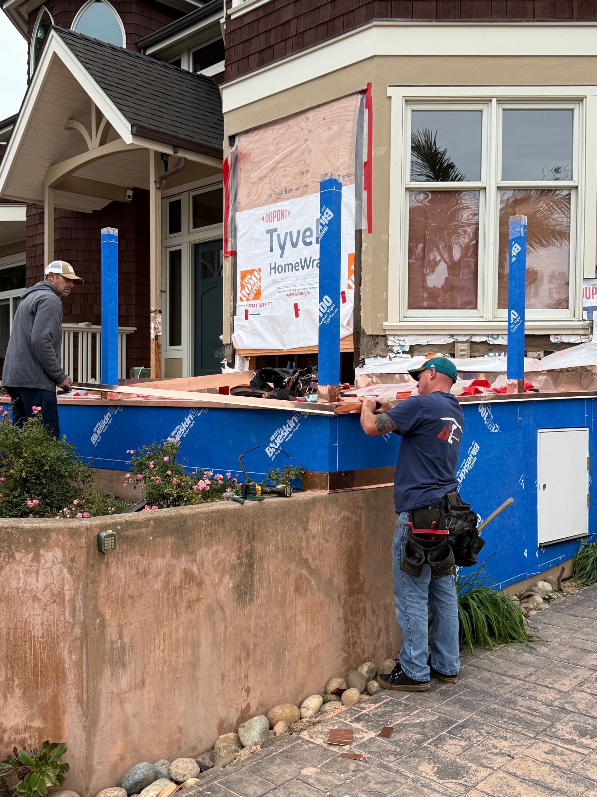 Large, silver HVAC system on a rooftop, with ductwork and cooling coils.