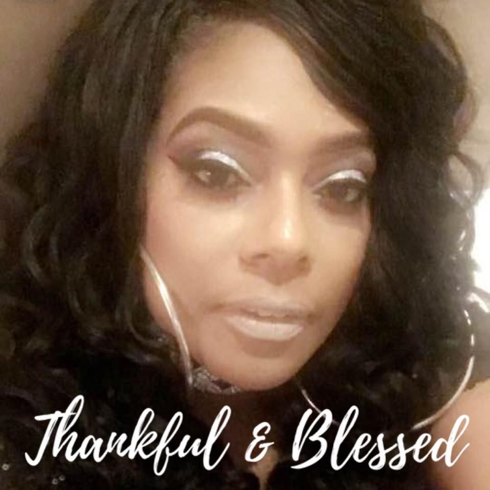 Woman with silver makeup, hoop earrings, and text 