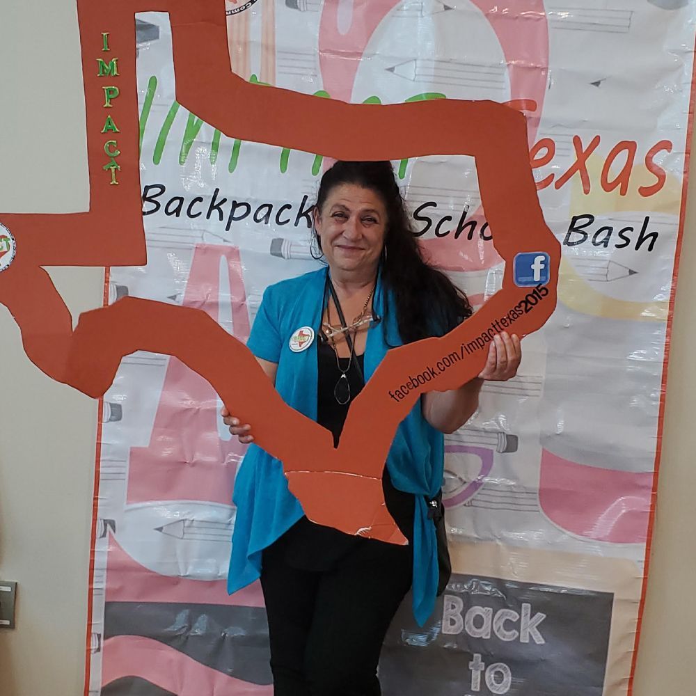 Woman holding a cutout of Texas at a