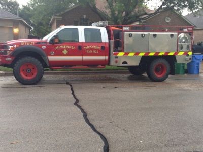 Red and white fire truck parked on a street; 