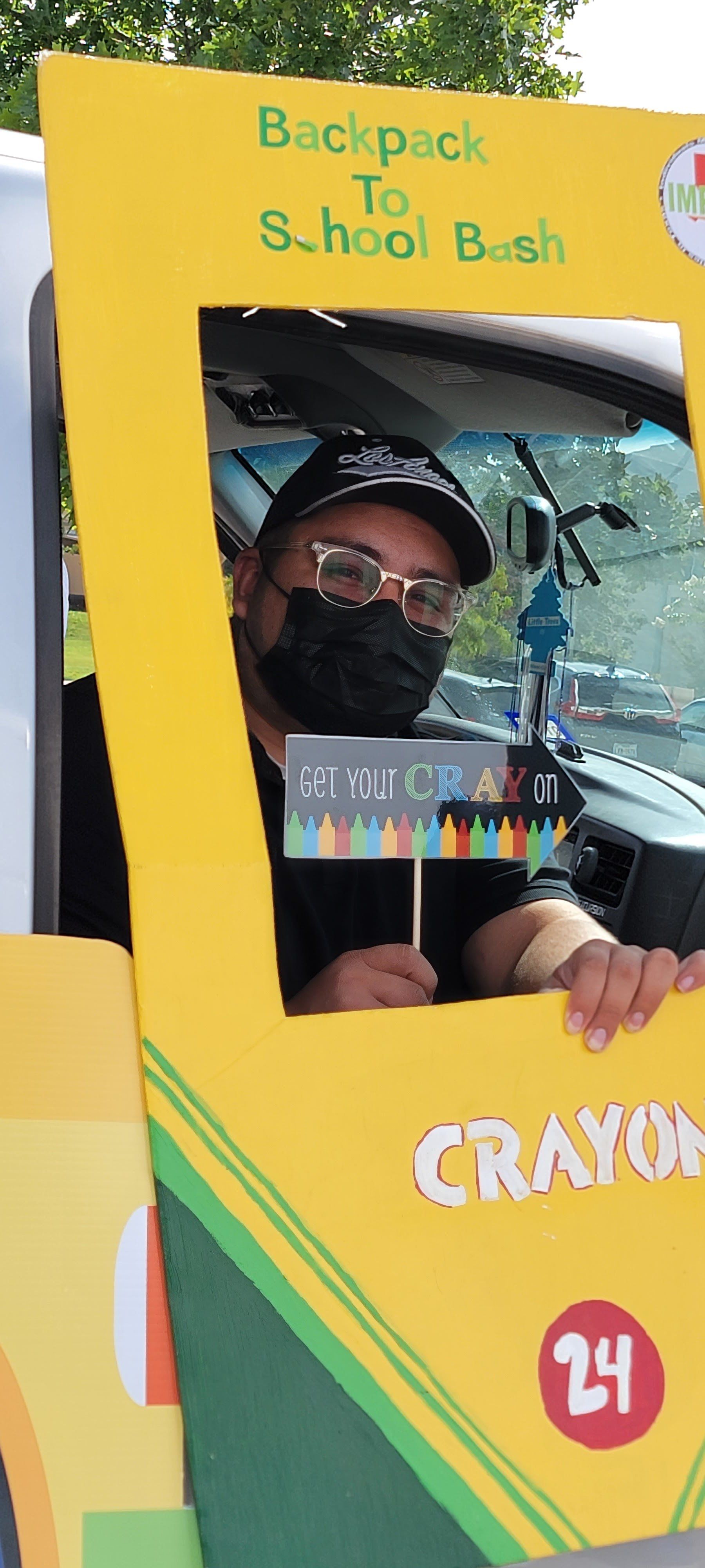 Man in black mask poses in photo frame that says 