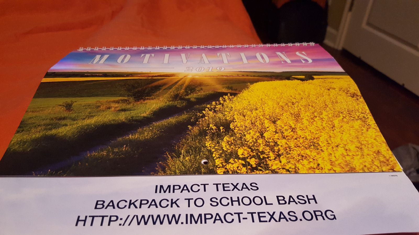 Calendar with a landscape photo and text for Impact Texas Backpack to School Bash.