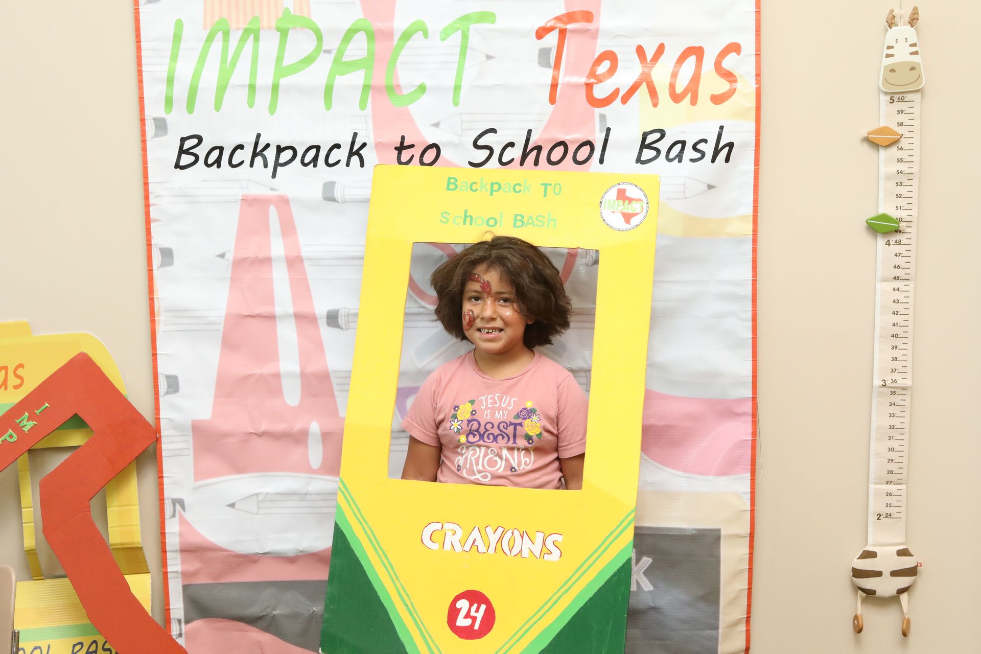 Girl in a crayon cutout at a 