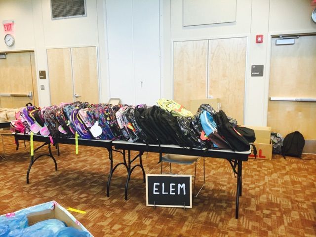 Backpacks on a table labeled 