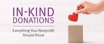Hand placing a red heart into a cardboard box. Text: In-Kind Donations. Everything Your Nonprofit Should Know.