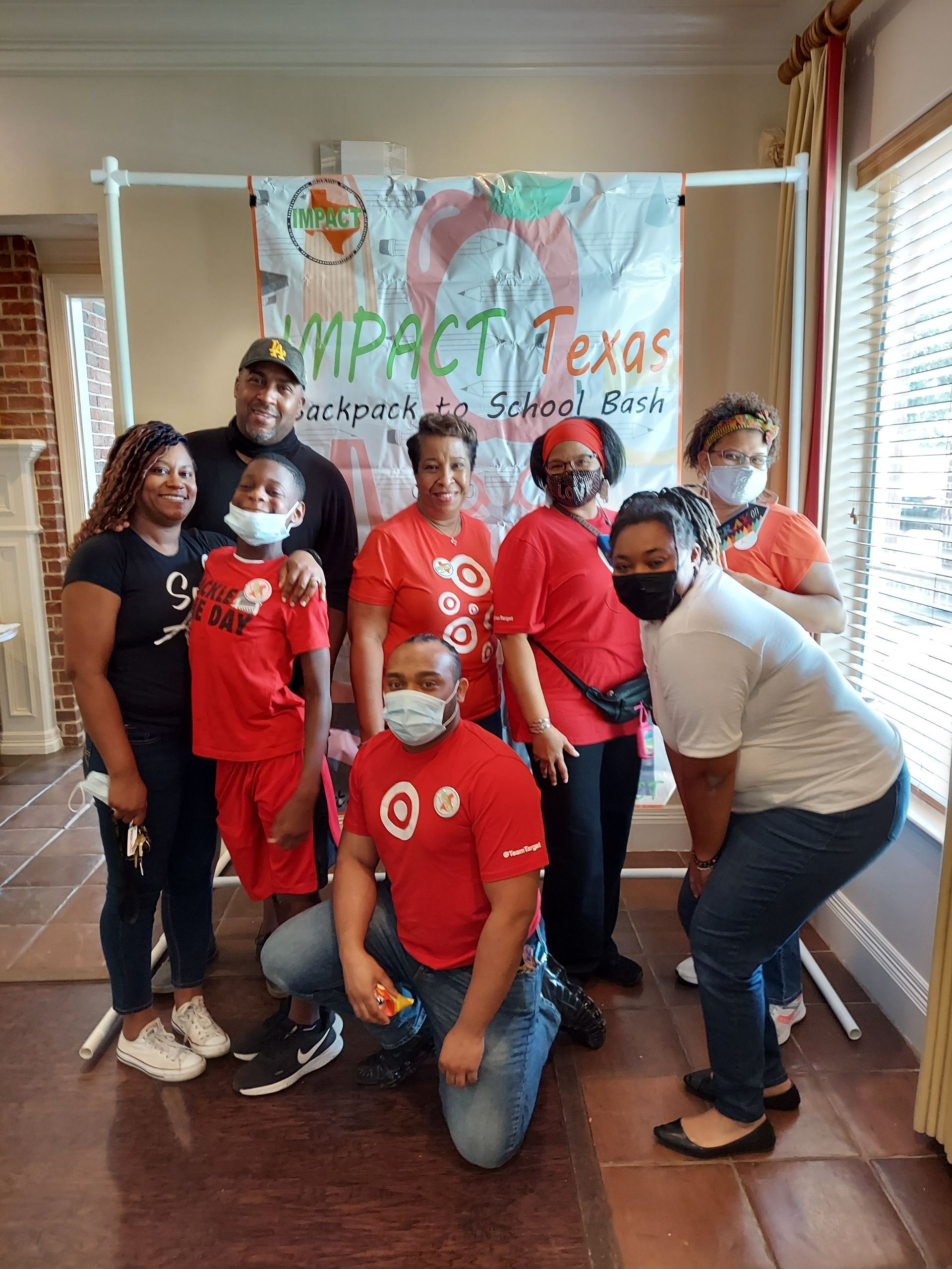Group of people posing in front of a banner that reads 