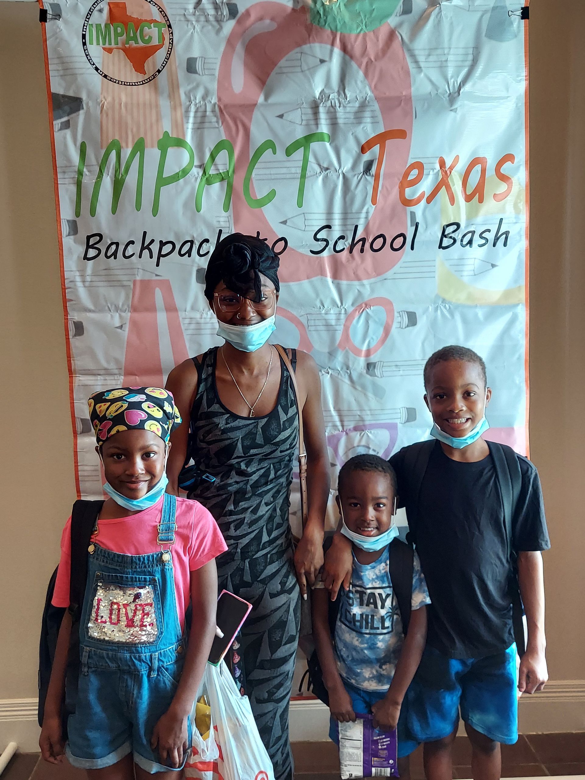 Family posing in front of a banner for a 