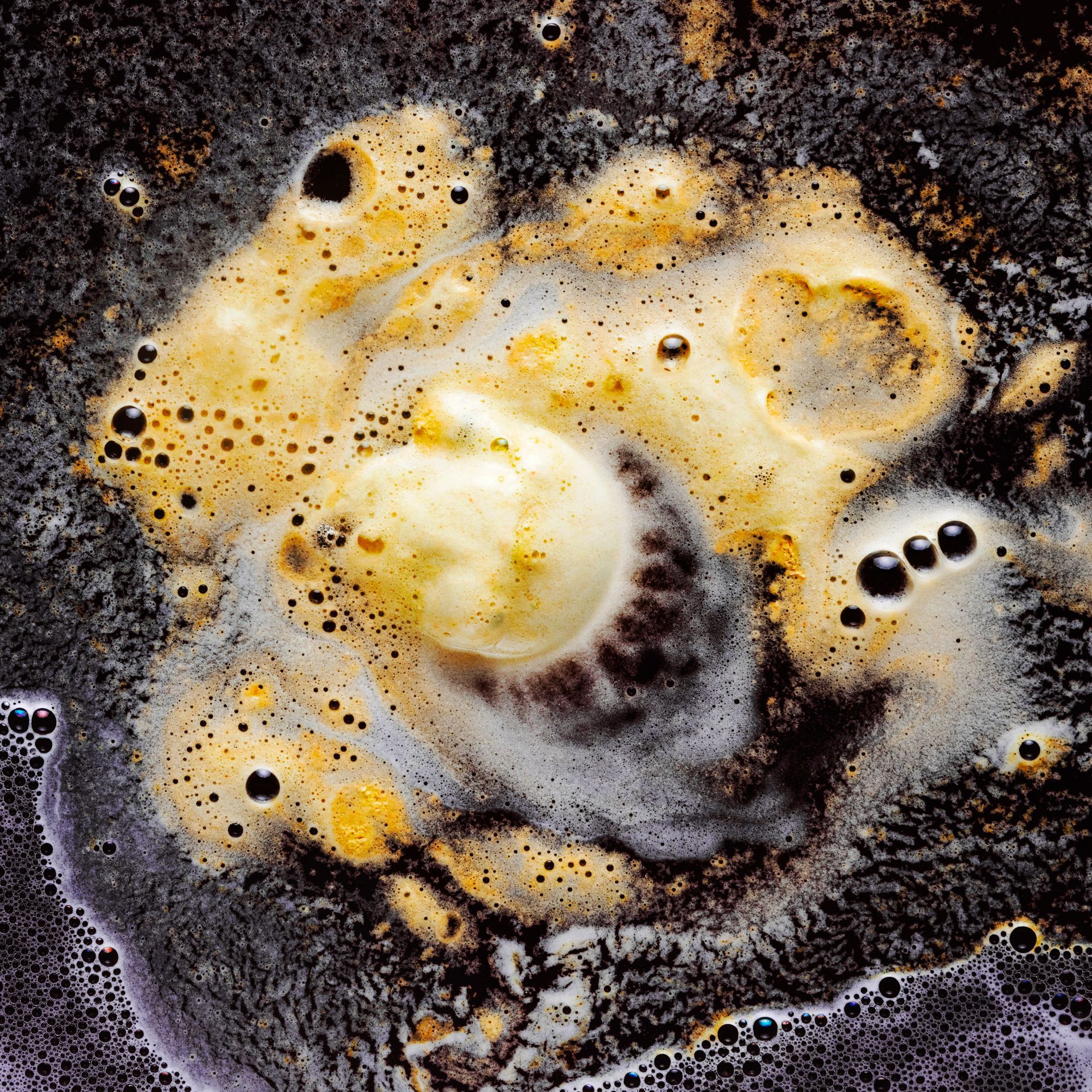 A close up of a brown liquid with bubbles in it