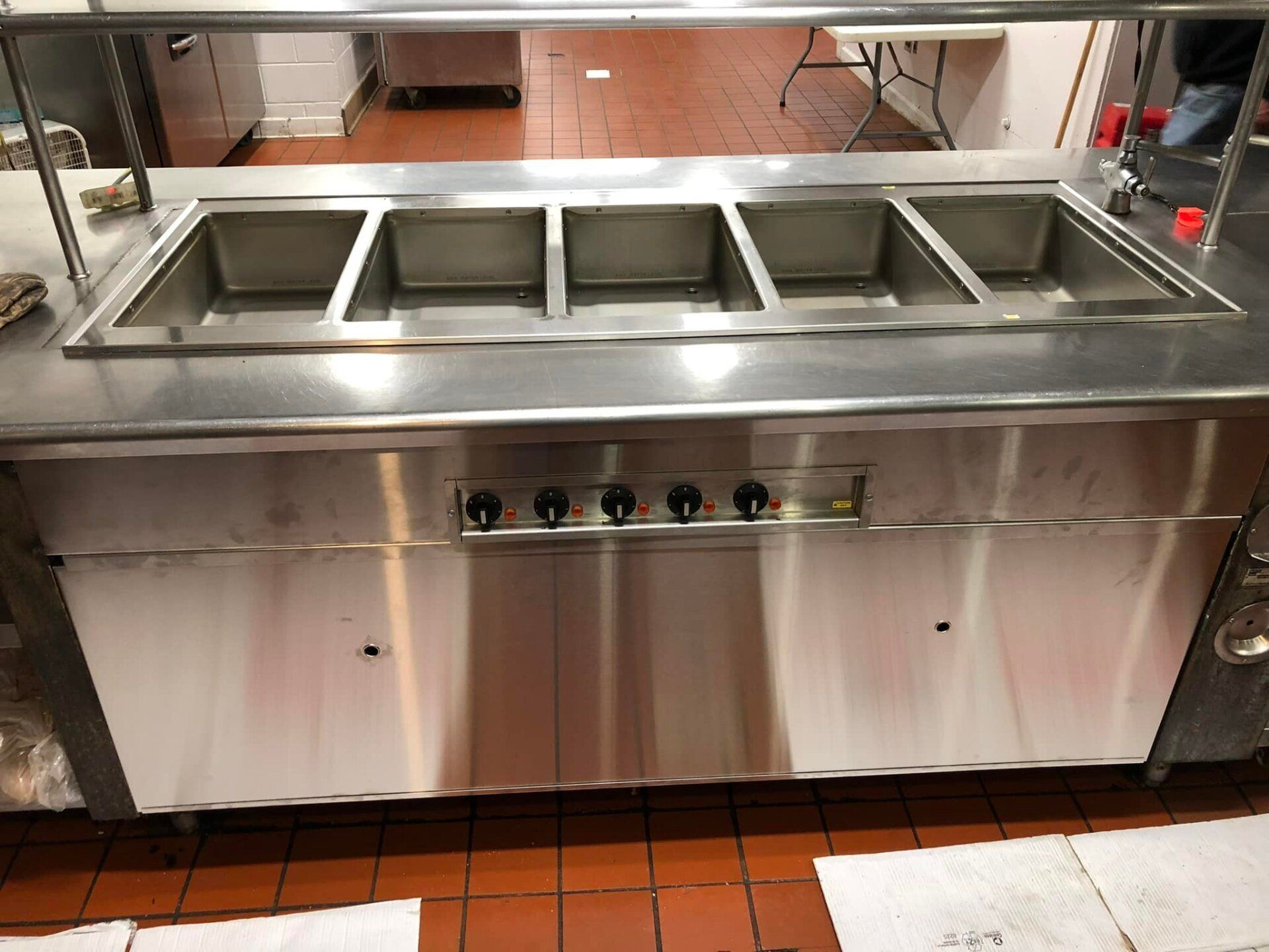 A stainless steel buffet line in a restaurant kitchen.