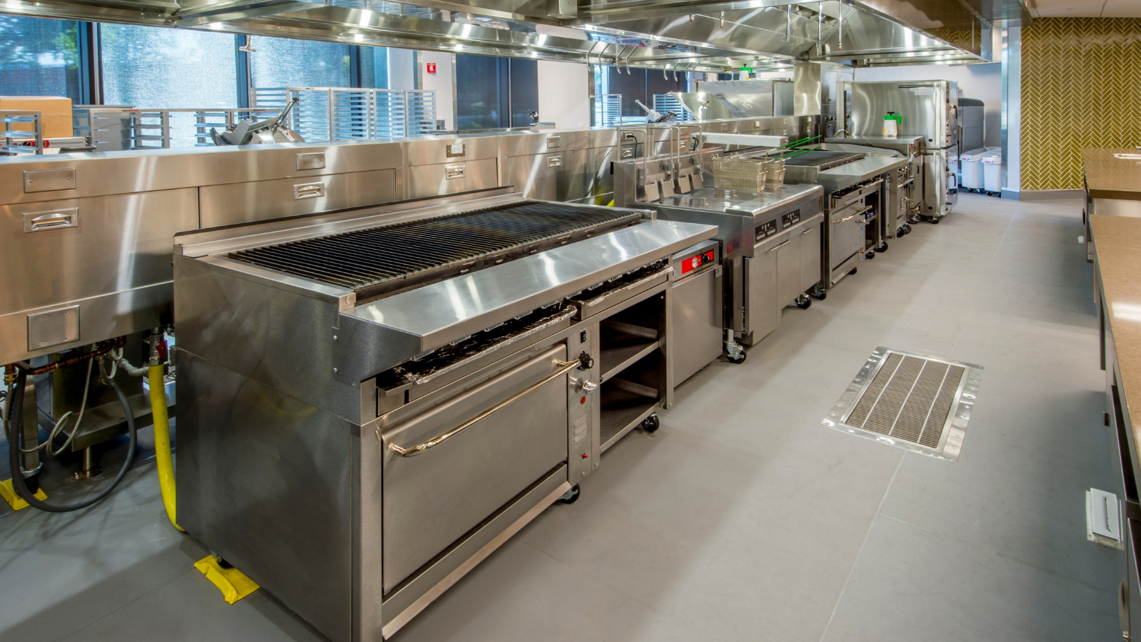 A large kitchen with a lot of stainless steel appliances.