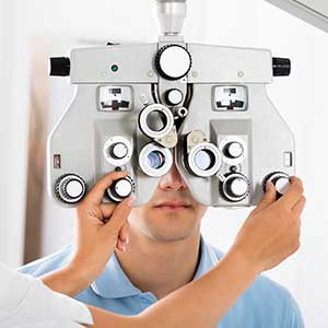 Optometrist — Optometrist Adjusting Phoropter For Patient in Lawton, OK