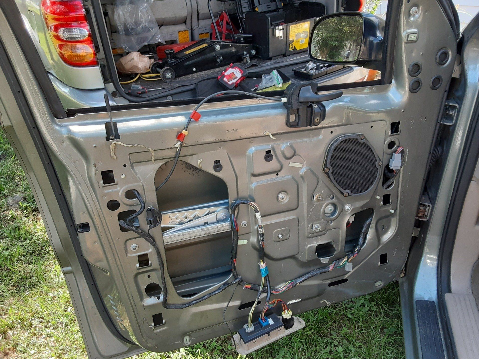 The back door of a car is being removed.