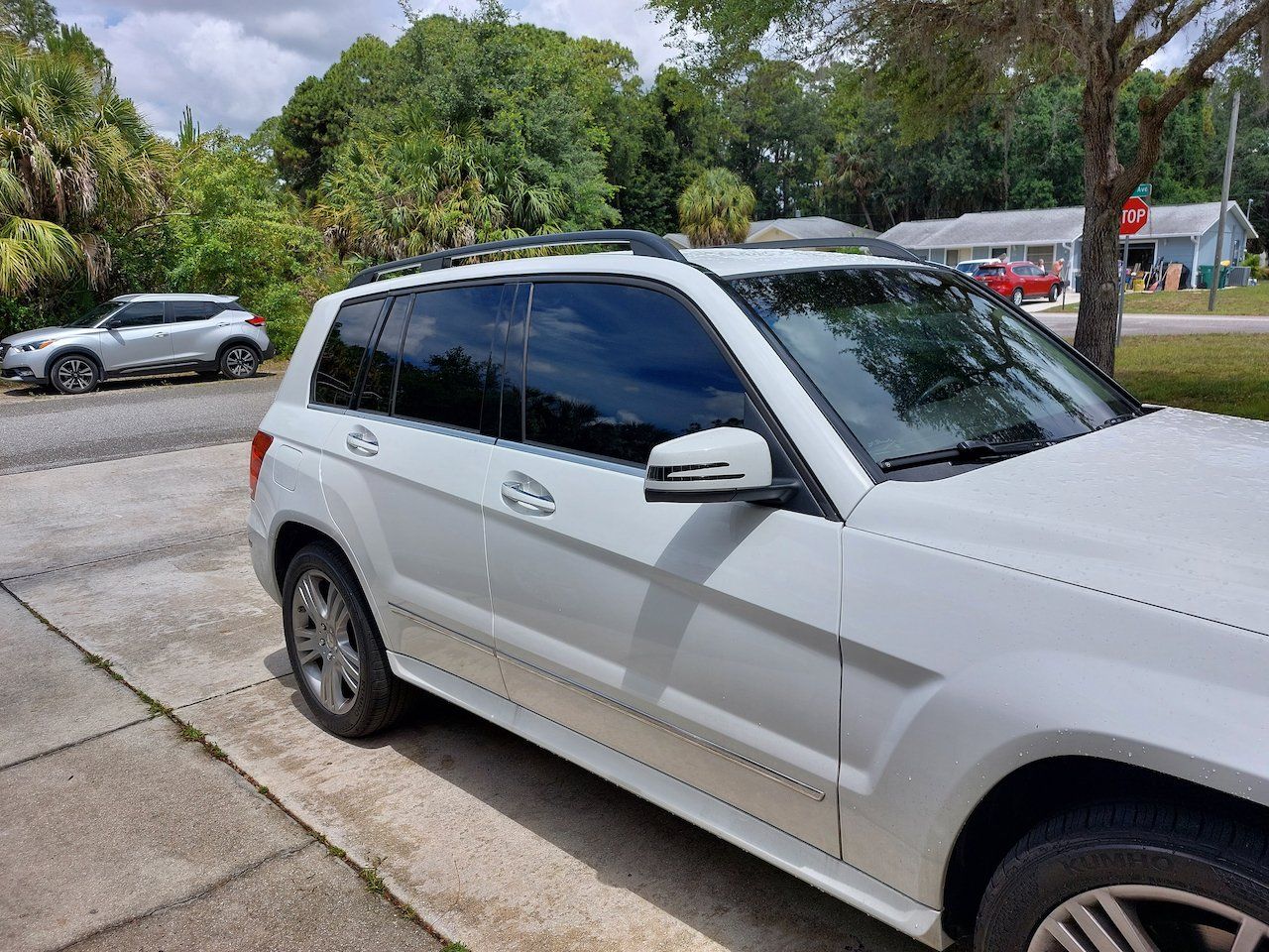 A white suv is parked on the side of the road.