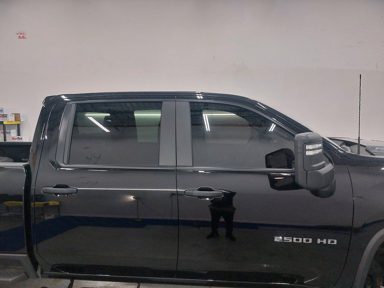 A black pickup truck is parked in a garage.