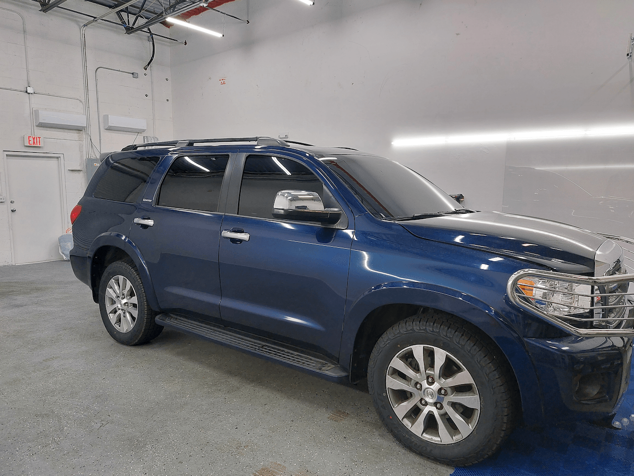 A blue suv is parked in a garage.