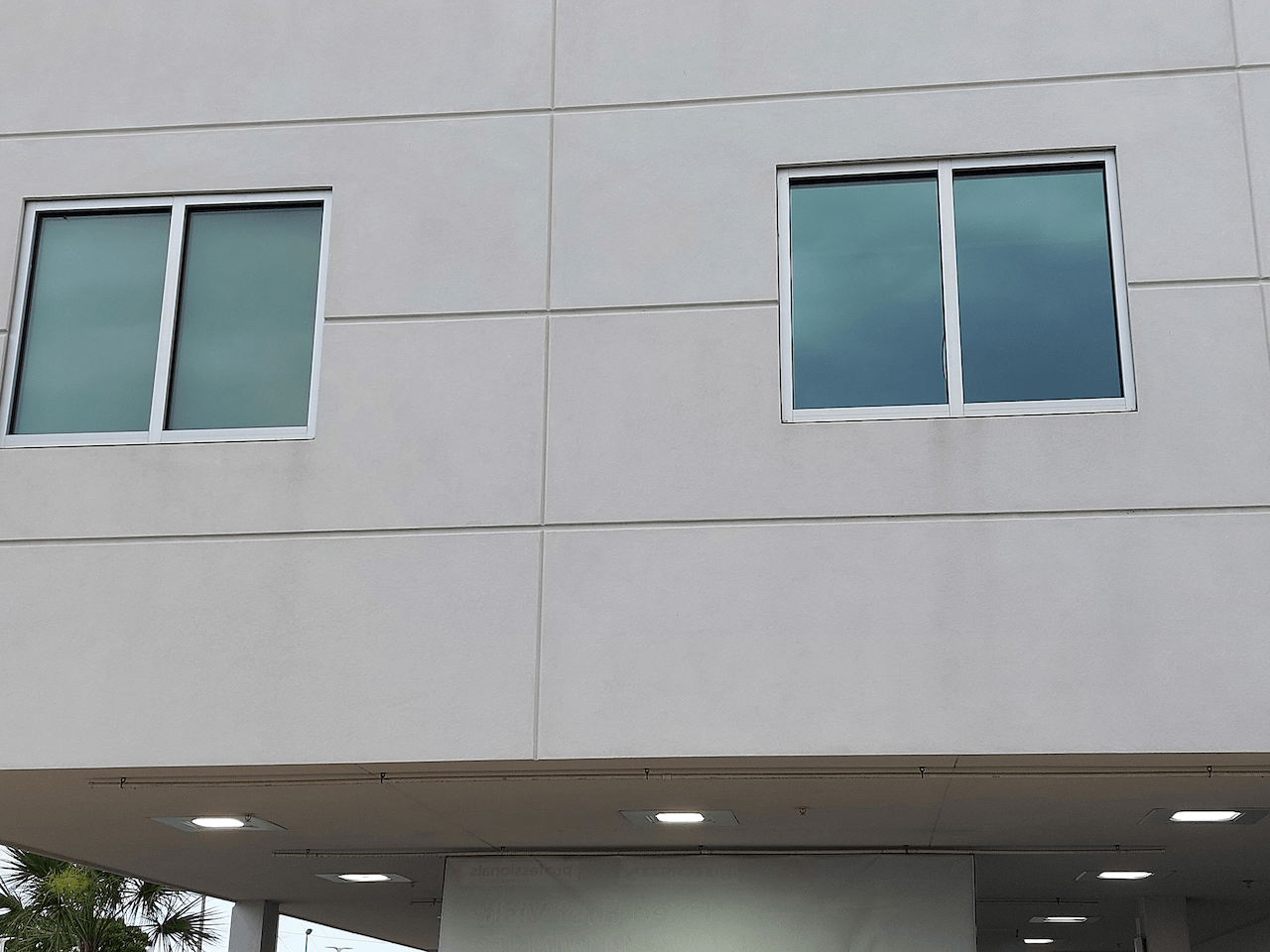 A building with two windows on the side of it