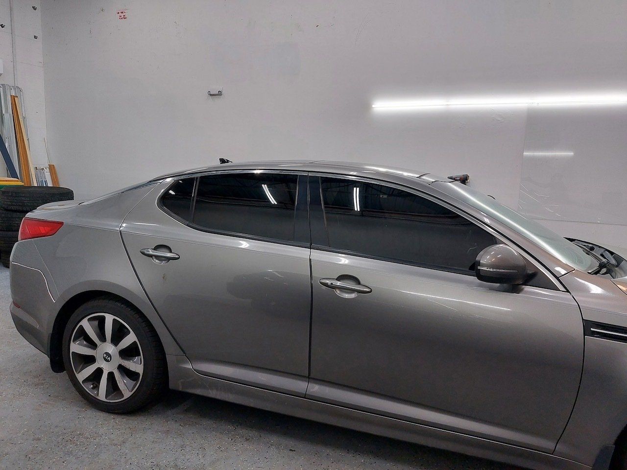 A silver car is parked in a garage.