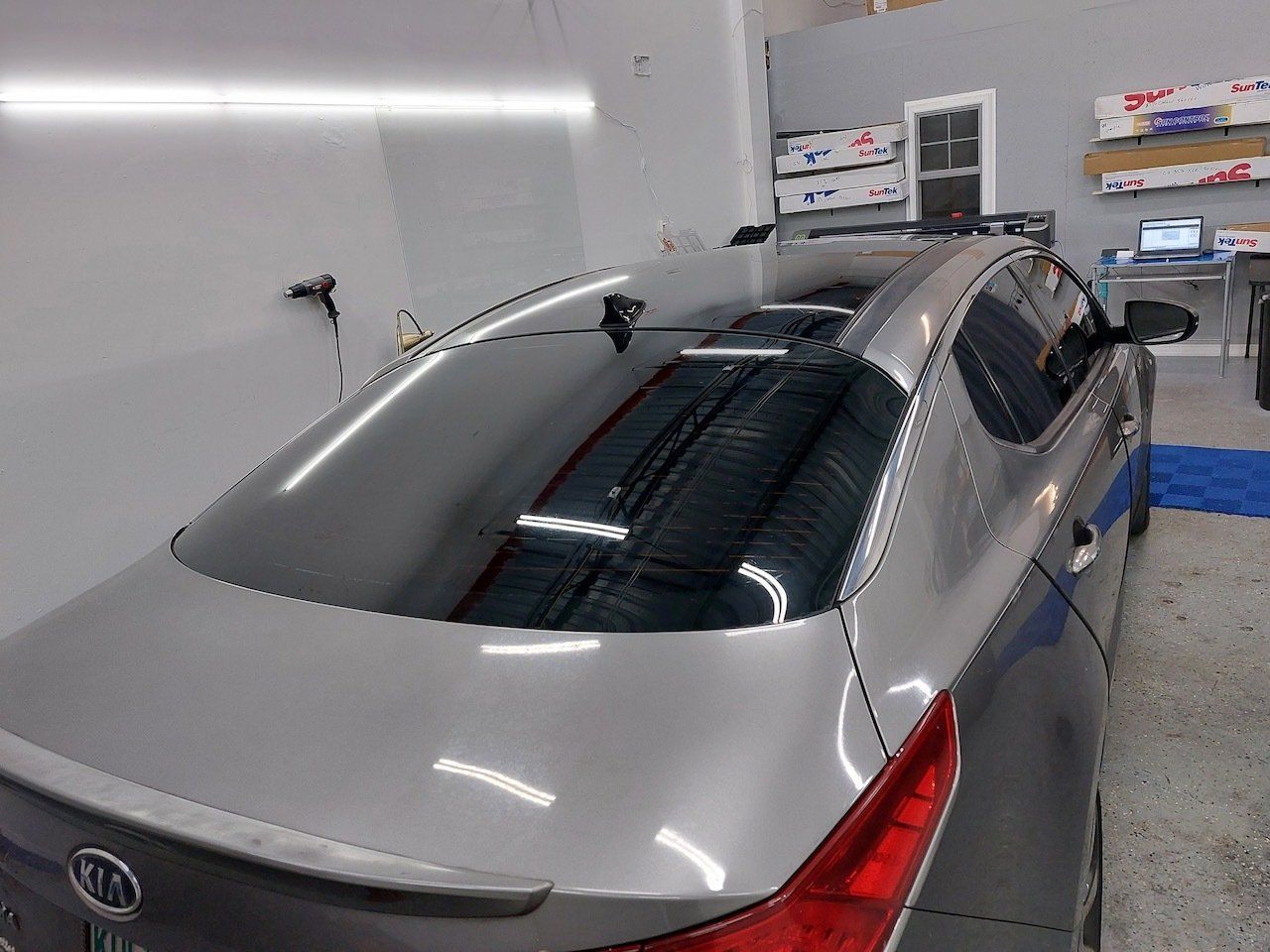 A silver car is parked in a garage.