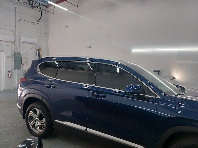 A blue suv is parked in a garage.