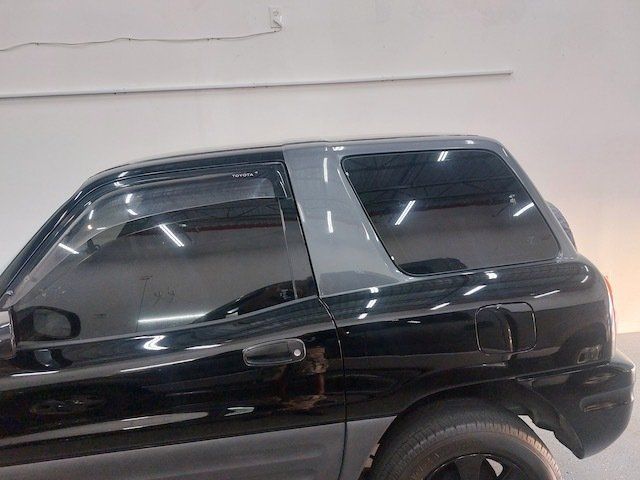 A black suv is parked in a garage.