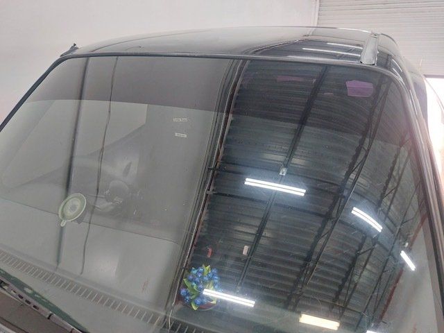 A close up of a car windshield in a garage.