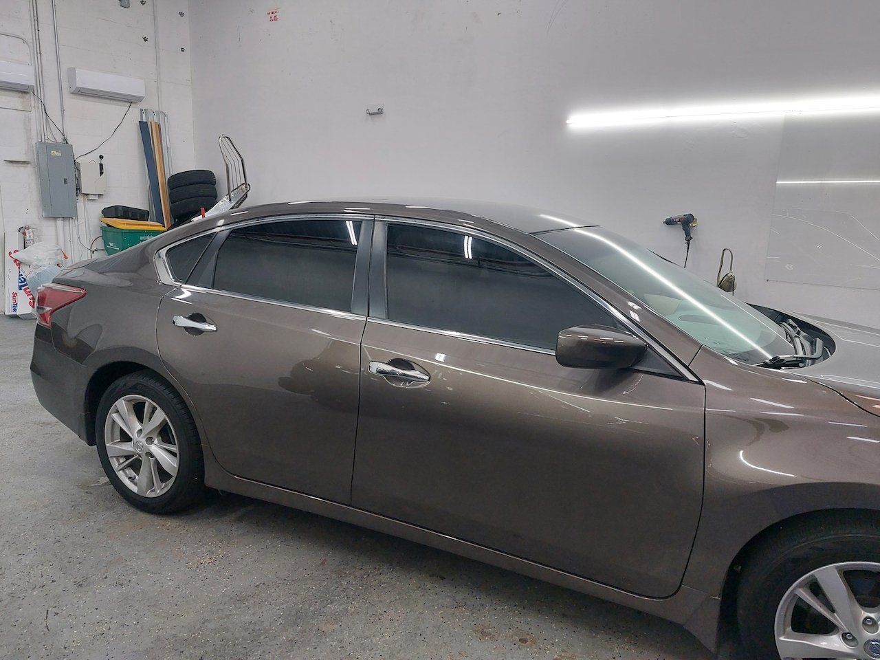 A brown car is parked in a garage.