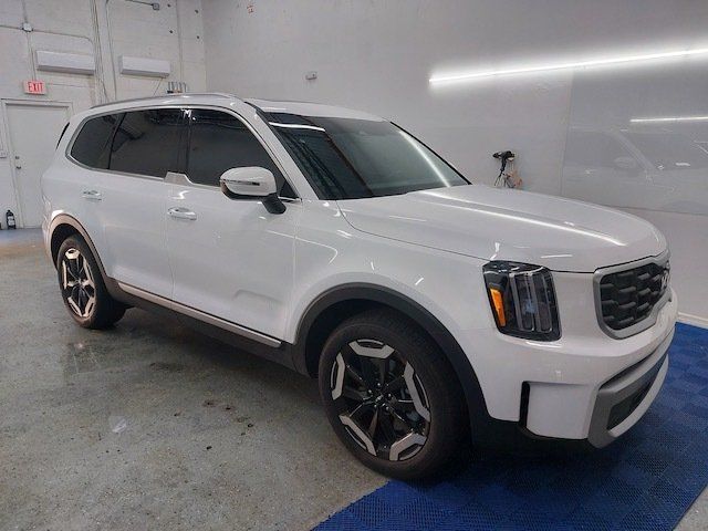 A white suv is parked in a garage.