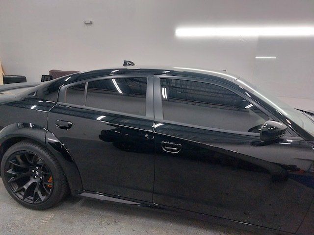 A black car is parked in a garage.