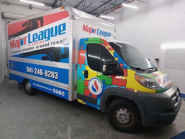 A major league truck is parked in a garage