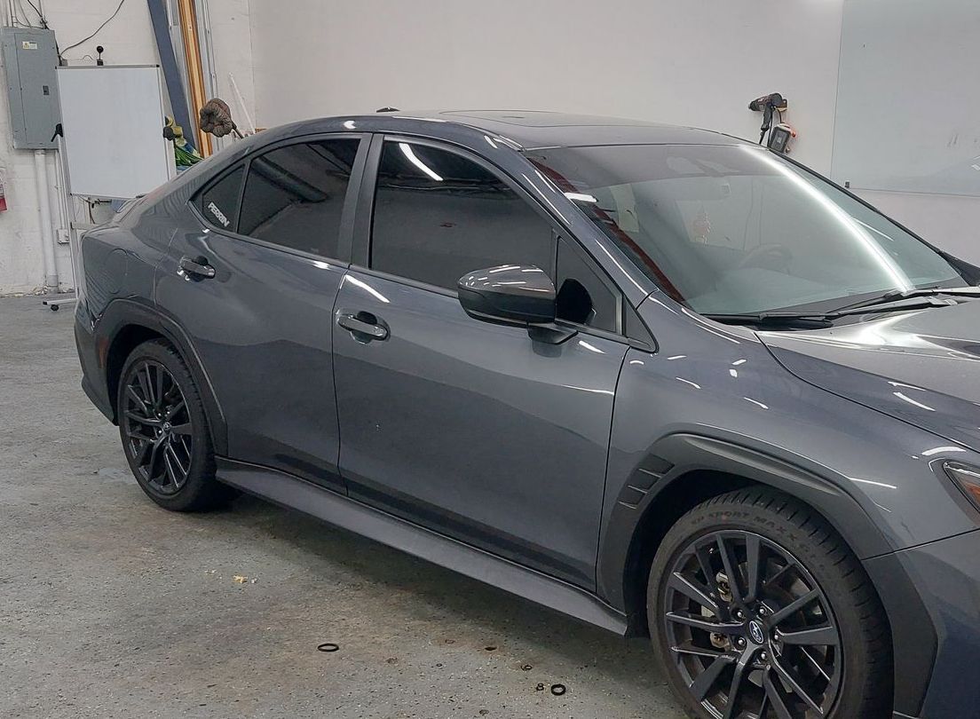 A gray car is parked in a garage.