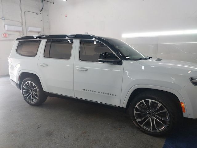 A white suv is parked in a garage.