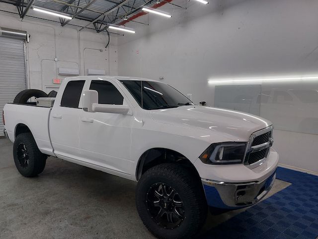 A white dodge ram truck is parked in a garage.