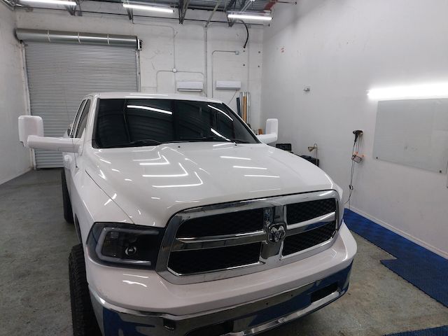 A white dodge ram truck is parked in a garage.